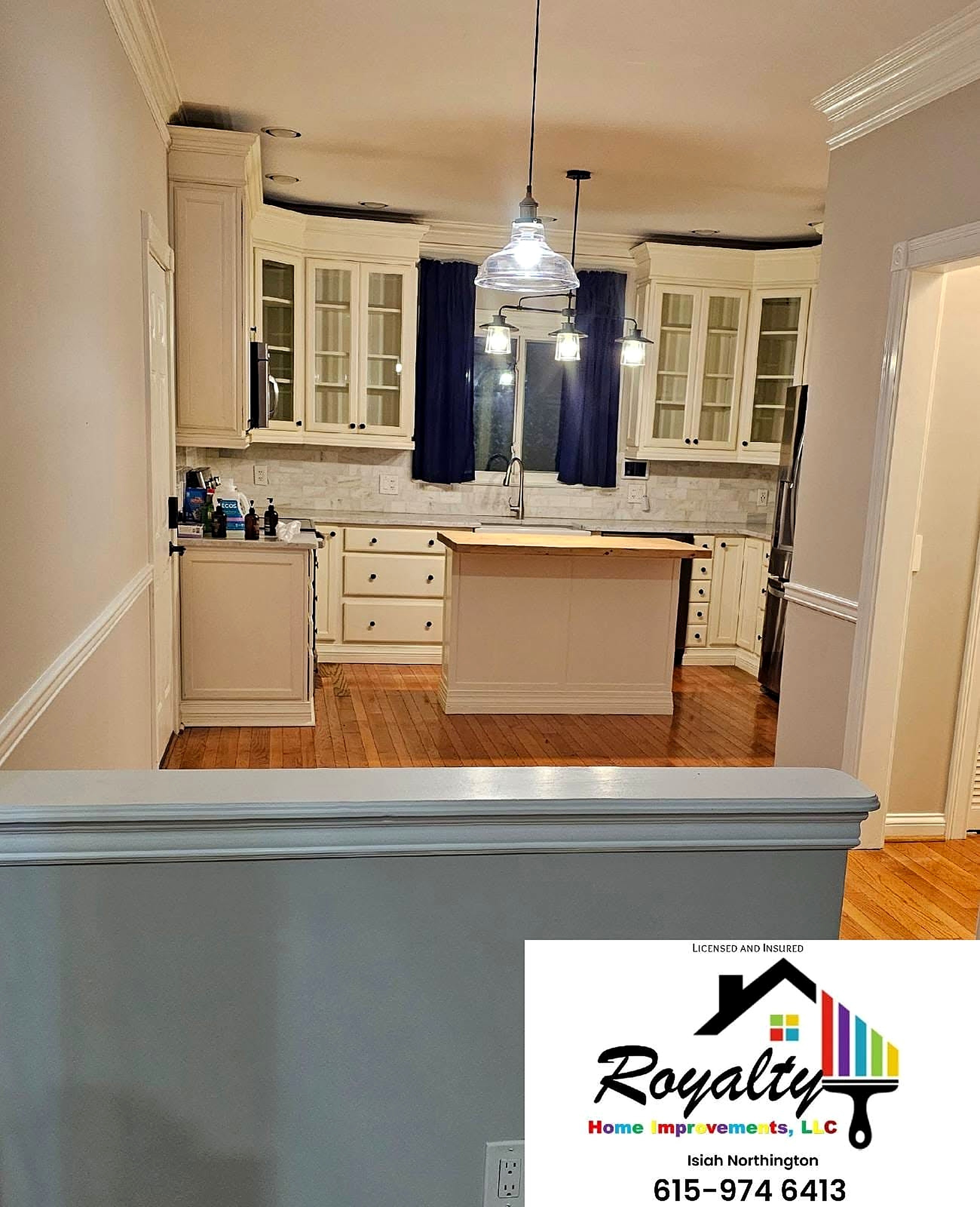 Bright painted kitchen with crisp white cabinets and a navy island