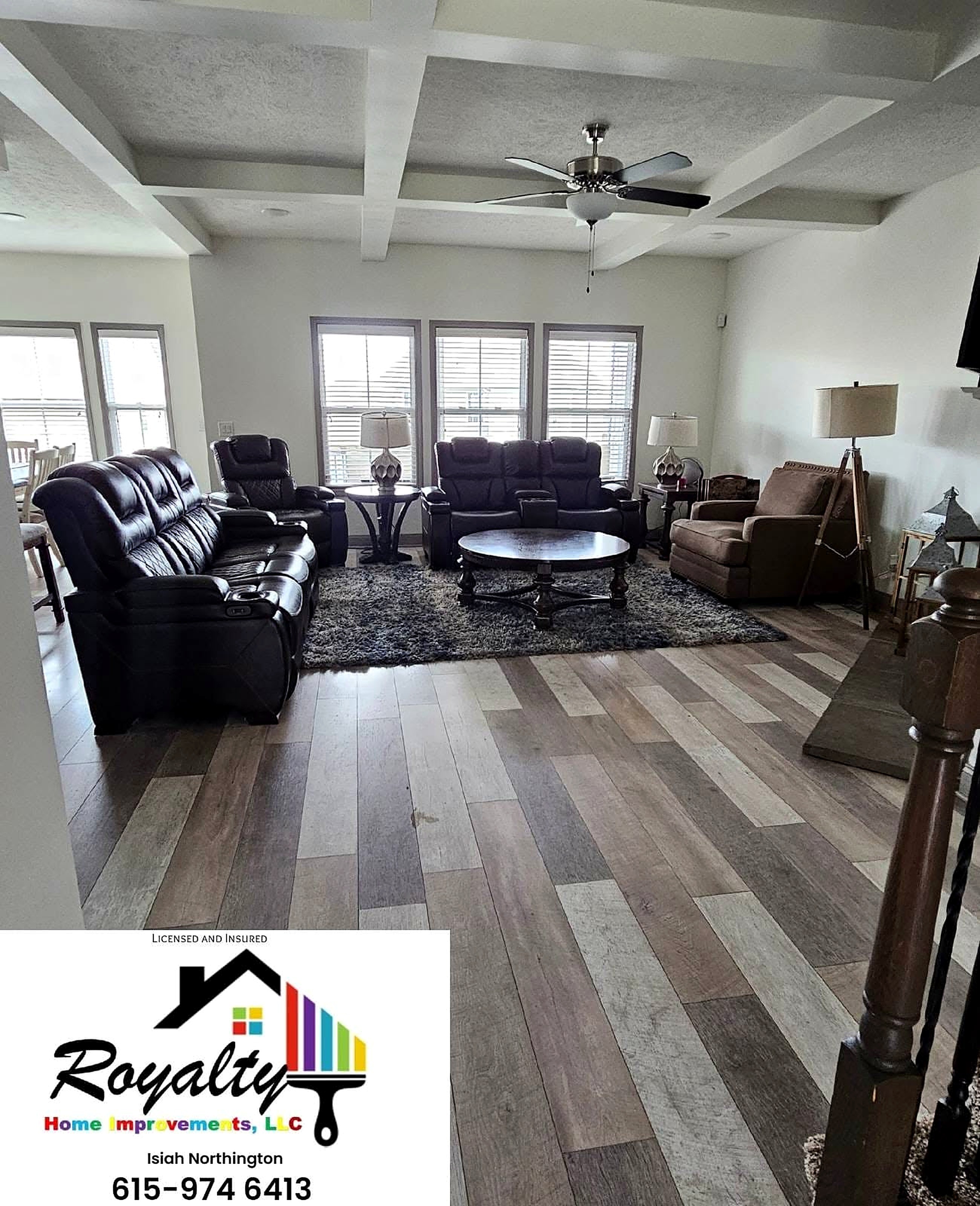 Finished living room with coffered ceiling and gray flooring