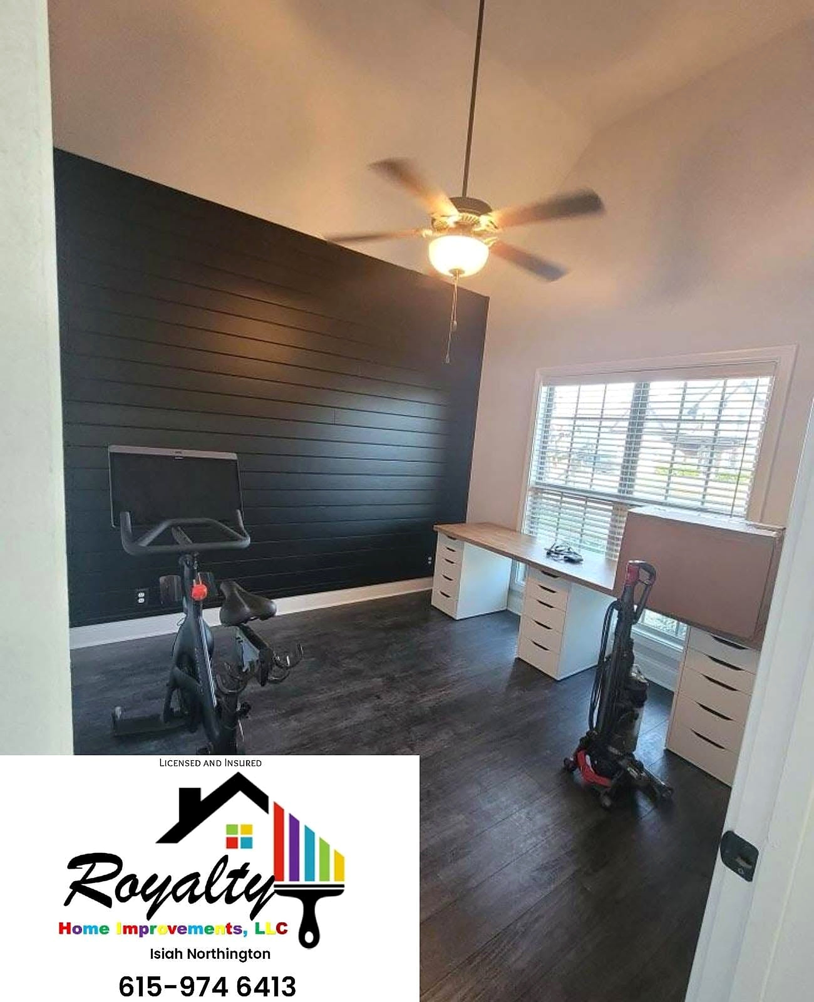 Bedroom with a rich dark accent wall and bright trim