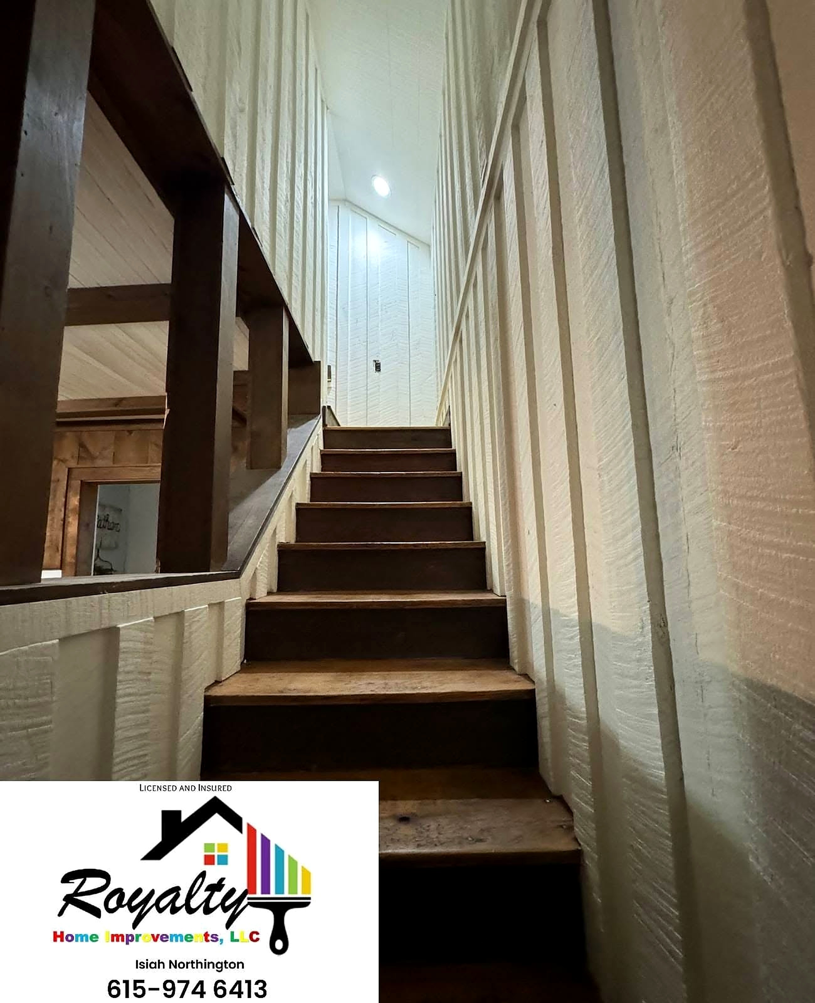 Freshly painted white stairwell with dark wood steps