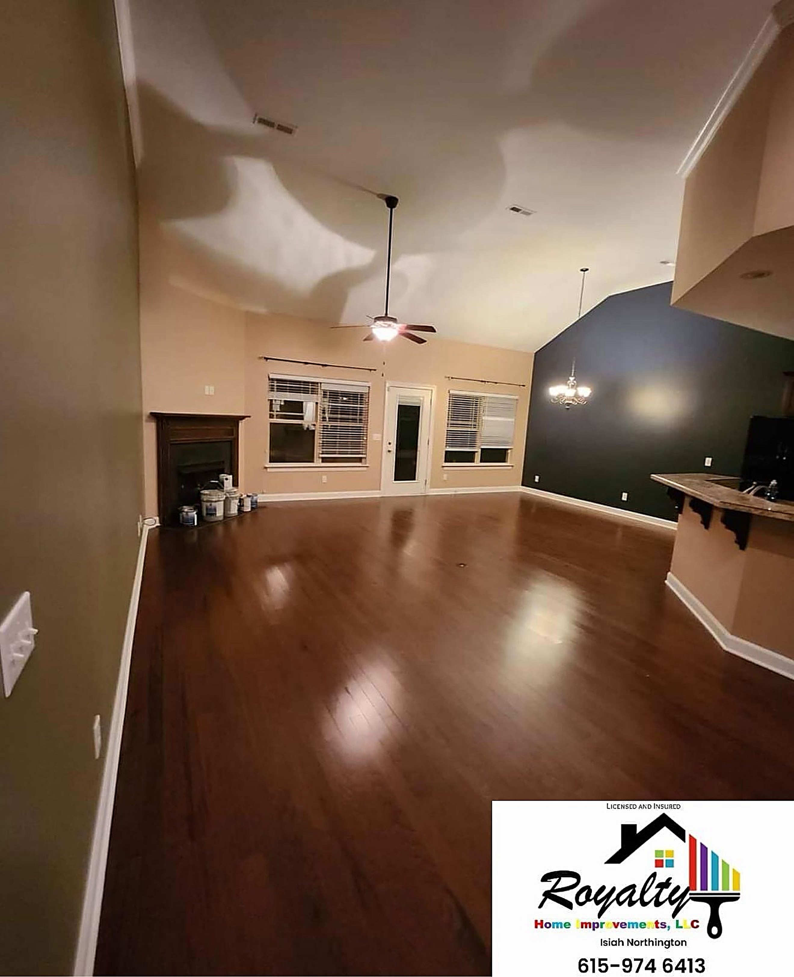 Open living room with warm walls and a dramatic dark accent wall