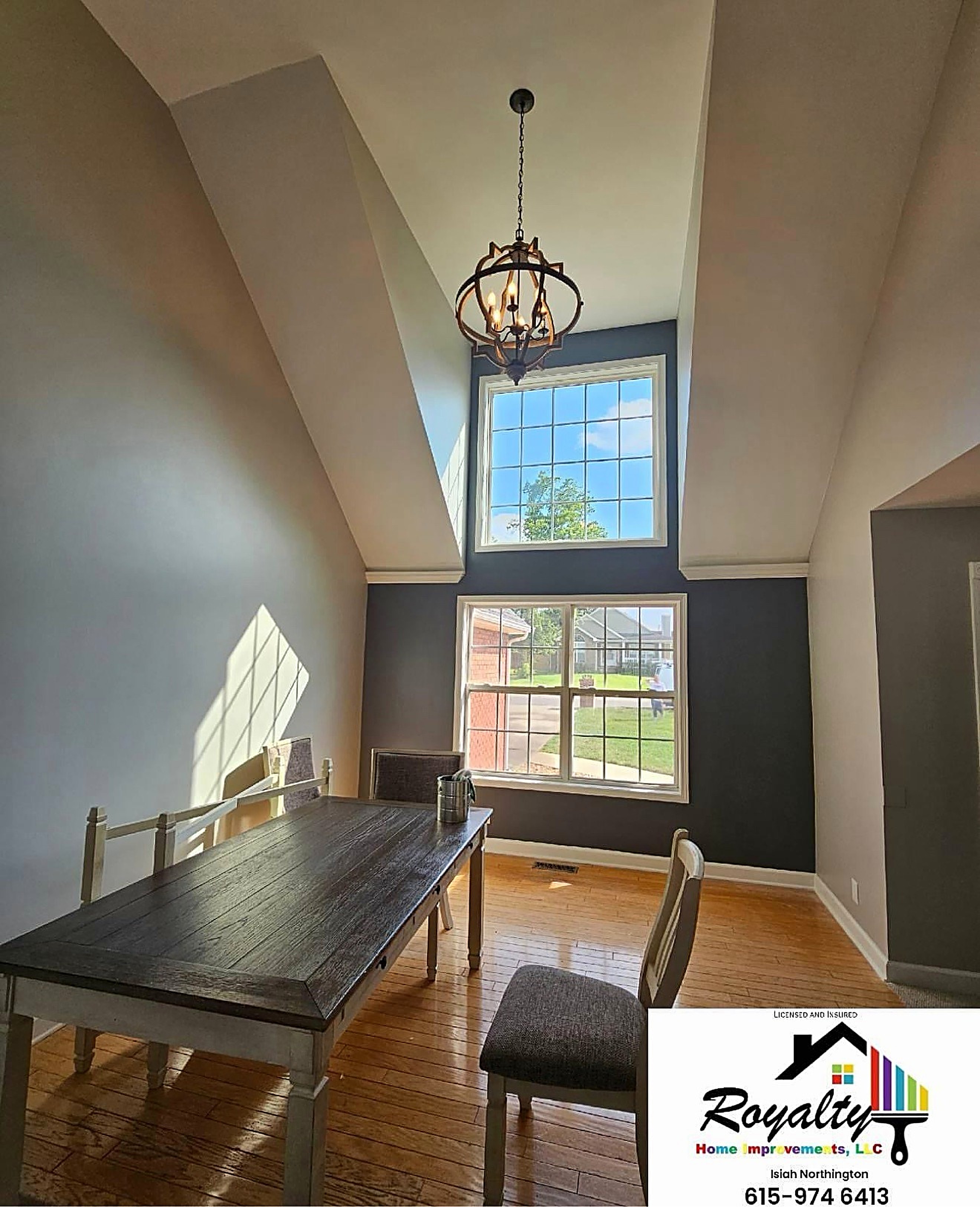 Tall dining room with warm neutral walls and bright window trim