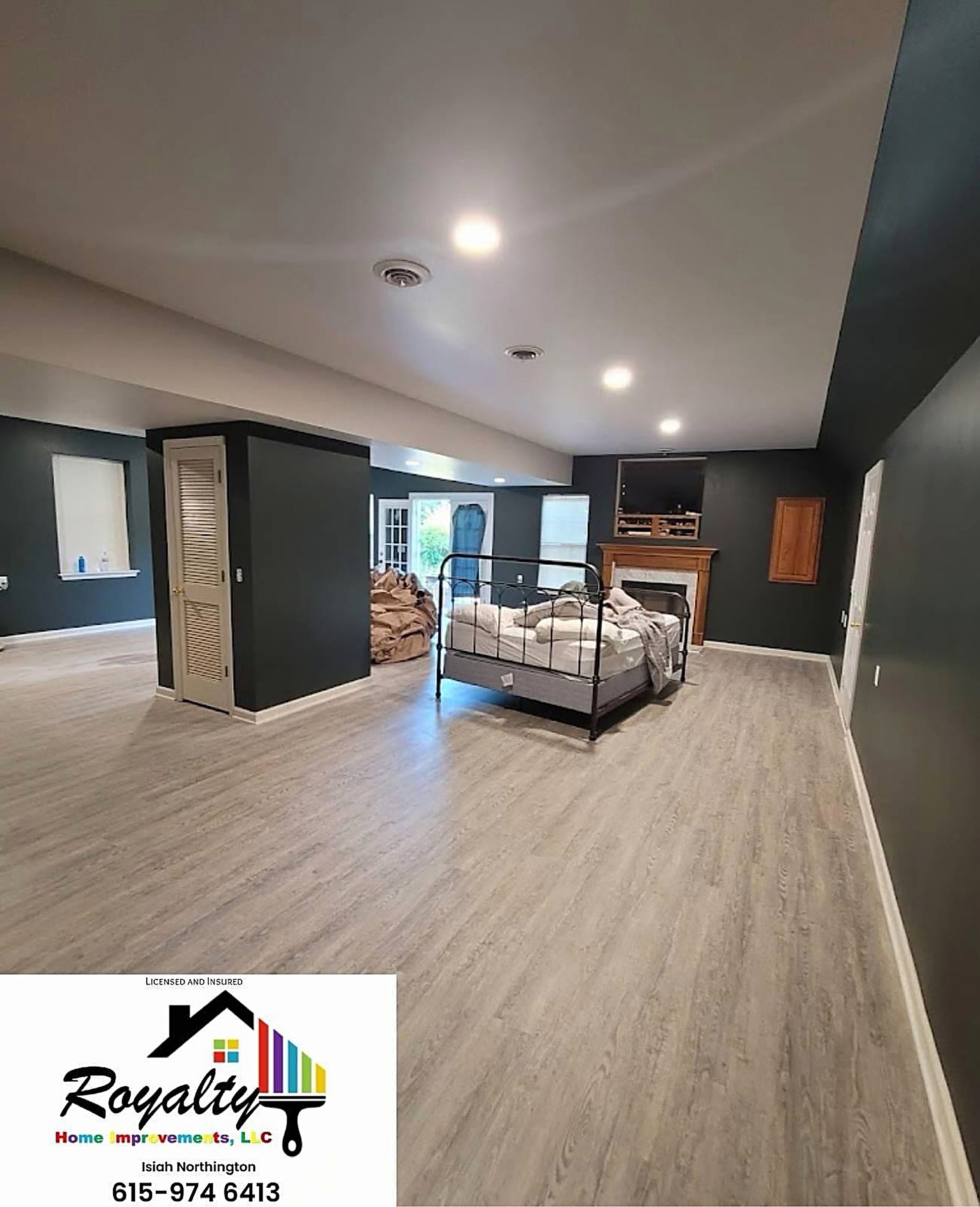 Finished bonus room with warm flooring and a dark accent wall