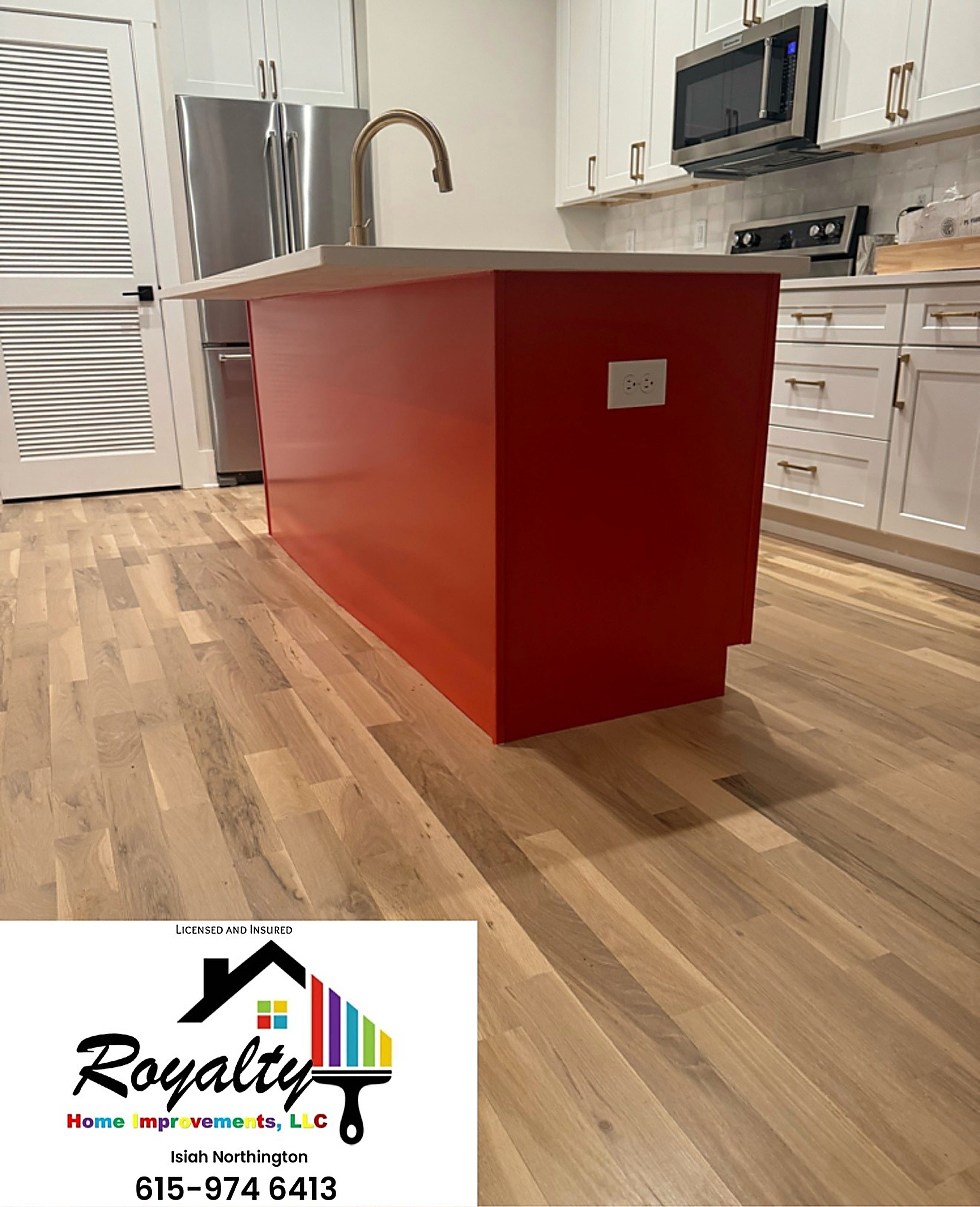 Kitchen with a bold red island and freshly finished surrounding walls